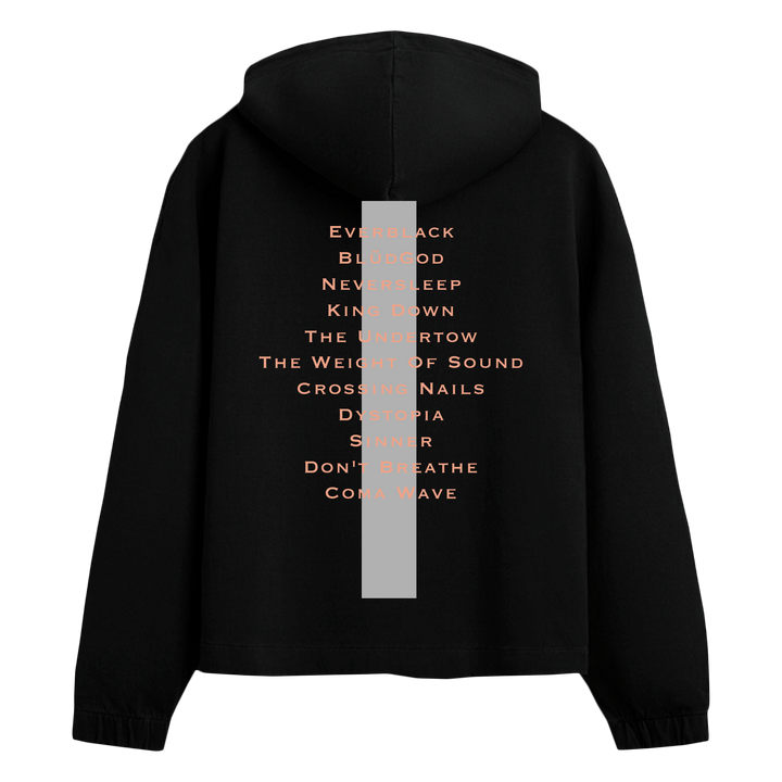 A black hooded sweatshirt by Crystal Lake is shown from the back, featuring a vertical gray stripe and orange song titles down the center—a standout printed apparel piece for music fans.