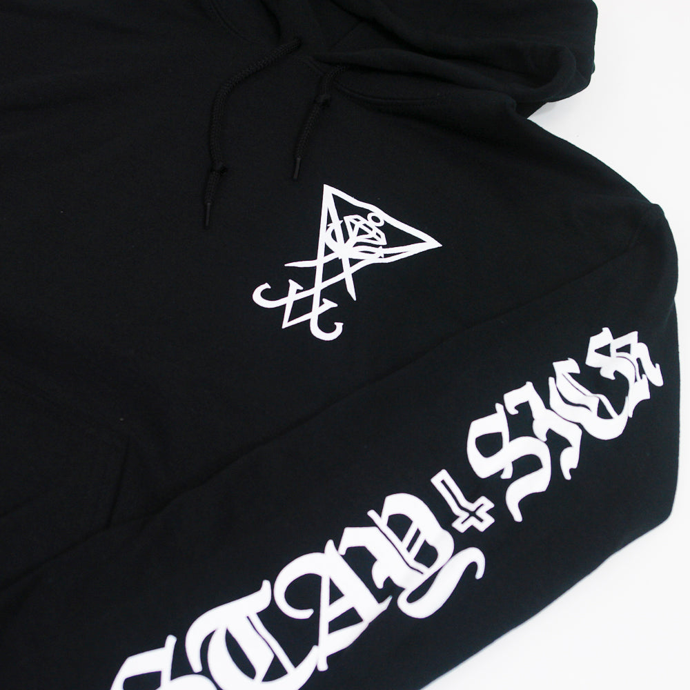 Stay Sick Clothing black hoodie with a white geometric symbol on the chest and “STAY SICK” in bold, ornate white lettering down the sleeve.