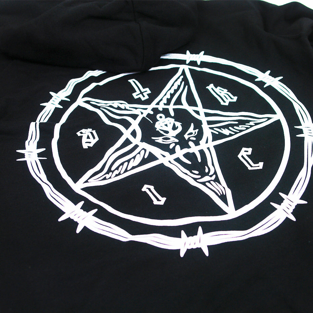 A white pentagram with a goat’s head and barbed wire is printed on cult black Stay Sick Clothing, likely a hoodie or shirt, with letters and symbols arranged around the points.