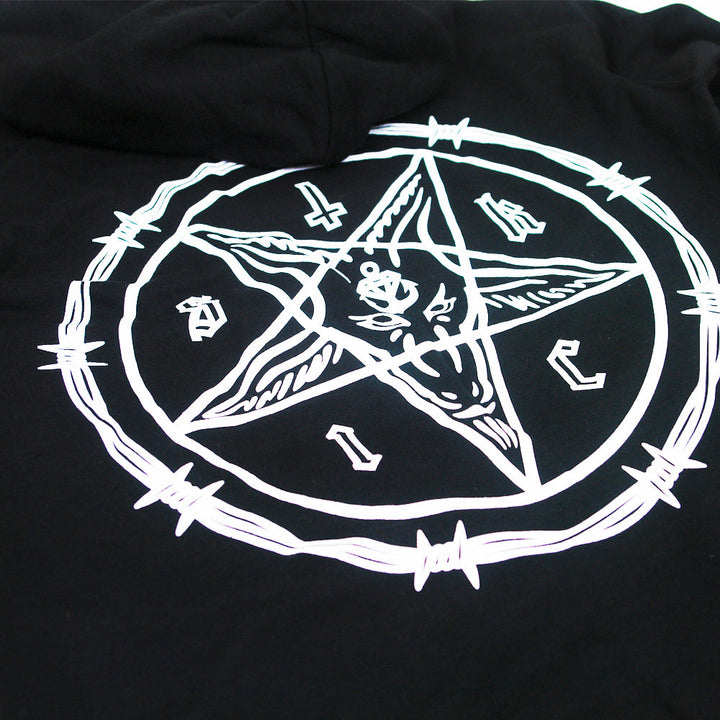 A white pentagram with a goat’s head and barbed wire is printed on cult black Stay Sick Clothing, likely a hoodie or shirt, with letters and symbols arranged around the points.