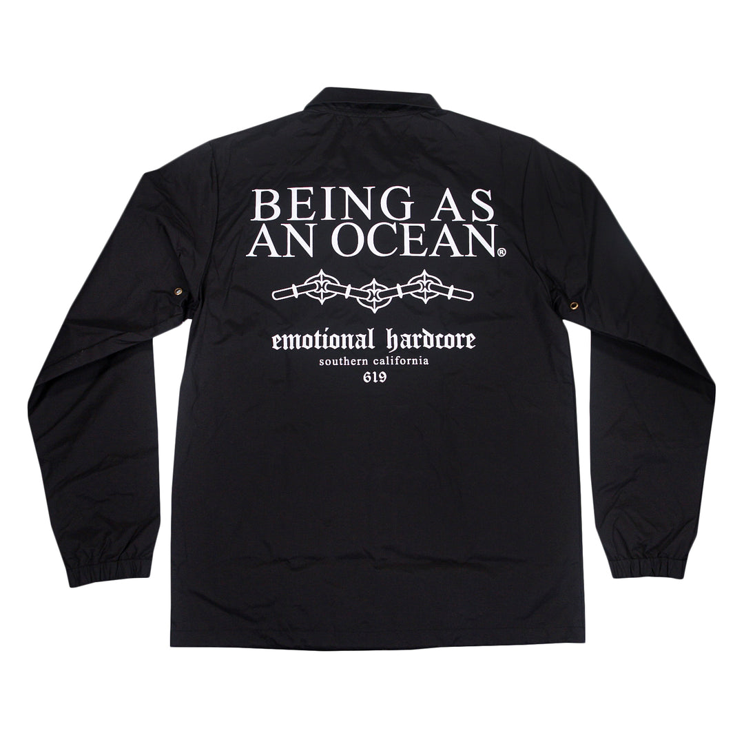Black windbreaker jacket with white text on the back that reads, BEING AS AN OCEAN, emotional hardcore, southern california, 619, and a graphic of barbed wire.