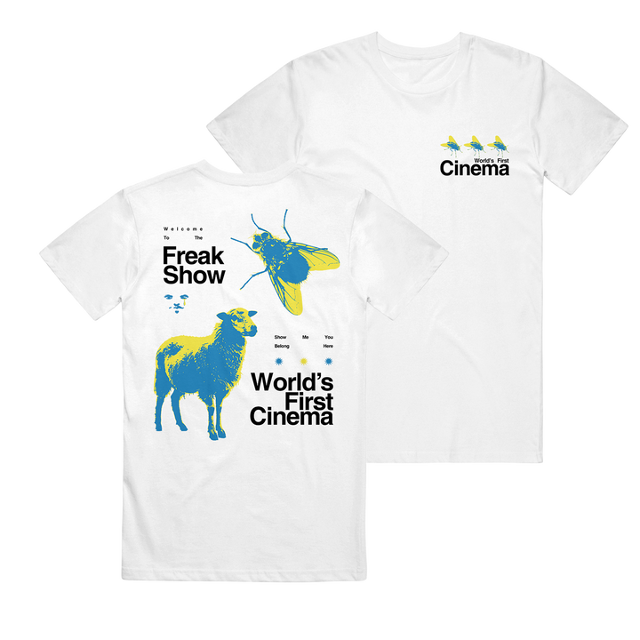 This World's First Cinema Comfort Colors tee features abstract blue/yellow sheep and beetle graphics on the back, three small birds on the front, and bold "Freak Show" and "World’s First Cinema" text.