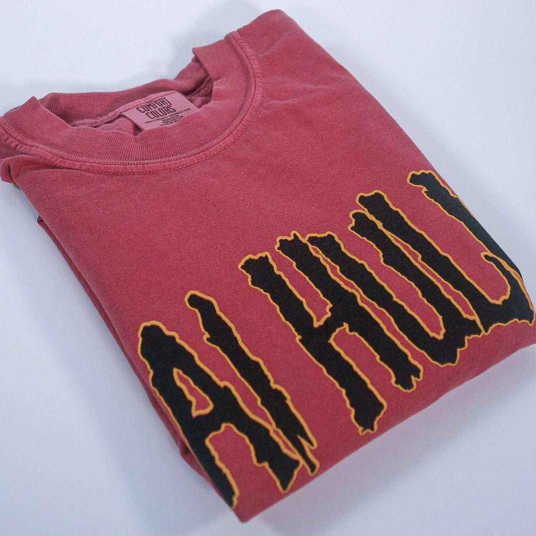 Folded brick tee with shai hulud text on a white background