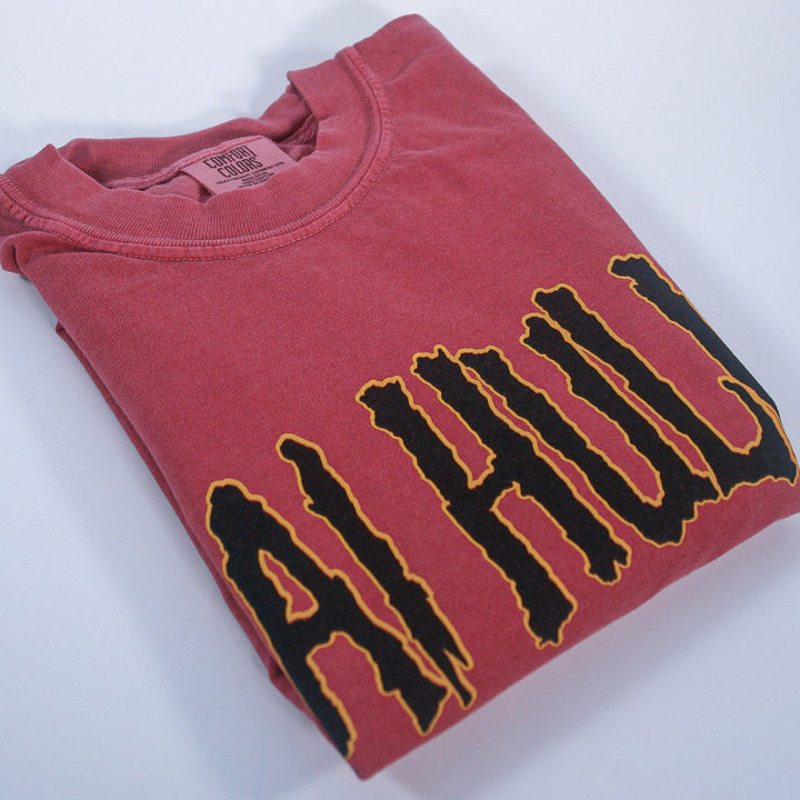 Folded brick tee with shai hulud text on a white background