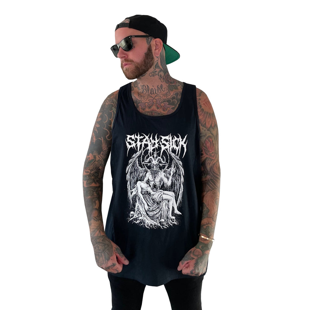 A tattooed man in sunglasses and a backward cap wears a Stay Sick Clothing Baphomet Tank Top with a gothic, illustrated demon-embracing-woman design and stylized text, standing against a plain white background.
