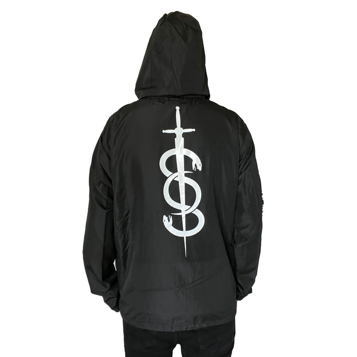 A person faces away from the camera against a white background, wearing a black Stay Sick Clothing zip-up jacket featuring a large white sword and snake graphic on the back.