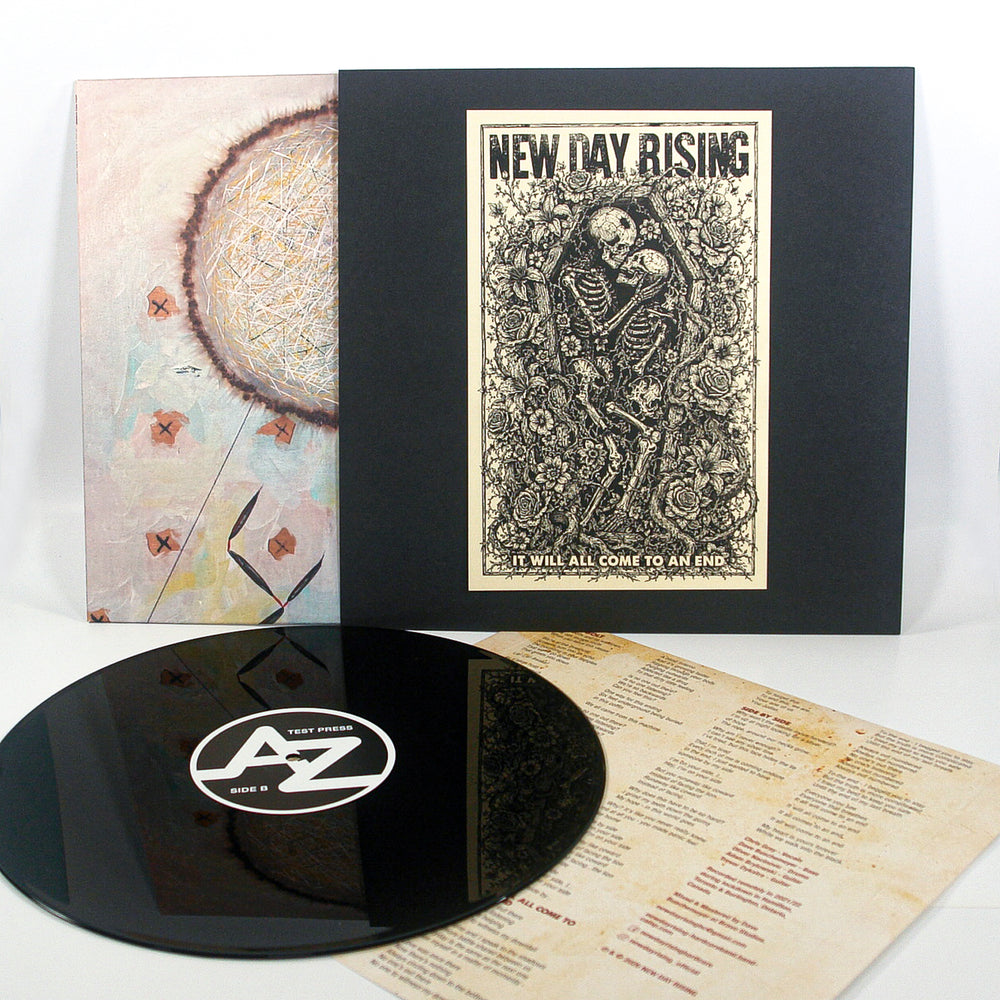 Test Press Black 12″ Vinyl record set including a disc with a test press label, a sleeve featuring a New Day Rising skeleton illustration, an abstract cover insert, and a lyric sheet.