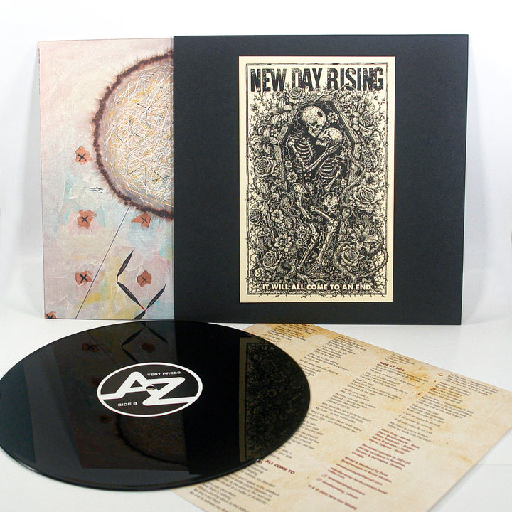 Test Press Black 12″ Vinyl record set including a disc with a test press label, a sleeve featuring a New Day Rising skeleton illustration, an abstract cover insert, and a lyric sheet.