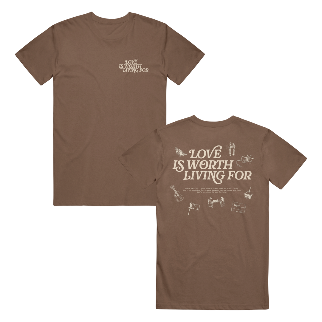 Joshua Bassett brown t-shirt featuring “Love is worth living for” text on the front left chest and large on the back, surrounded by small white illustrations like a guitar, piano, dog, and more.