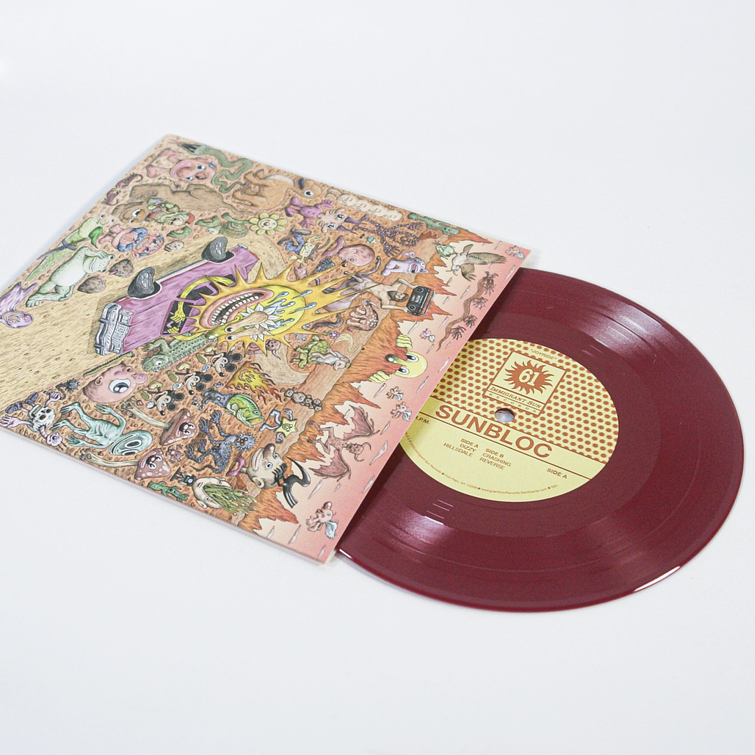 A maroon vinyl record by Sunbloc, titled Joyride EP, partially slides out of an illustrated cover with colorful cartoon characters and a purple car, reflecting the band's alternative hardcore music roots.
