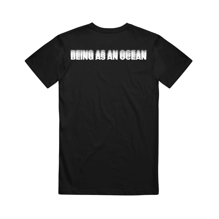 image of the back of a black tee shirt on a white background. the tee has a white print across the top shoulders in blurred text that says being as an ocean.