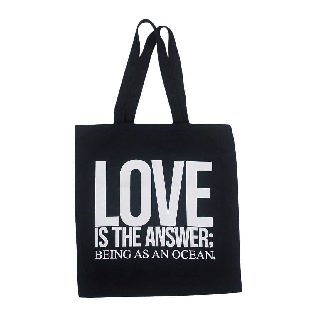 Black heavy cotton canvas tote bag with white text that reads LOVE IS THE ANSWER; BEING AS AN OCEAN.