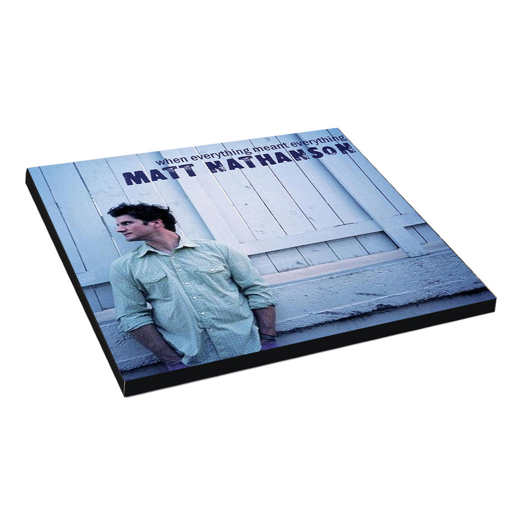 Album cover features a man in a light green shirt leaning against a white wooden wall. The text reads when everything meant everything and MATT NATHANSON, the artist’s brand name, in vivid purple and blue lettering.