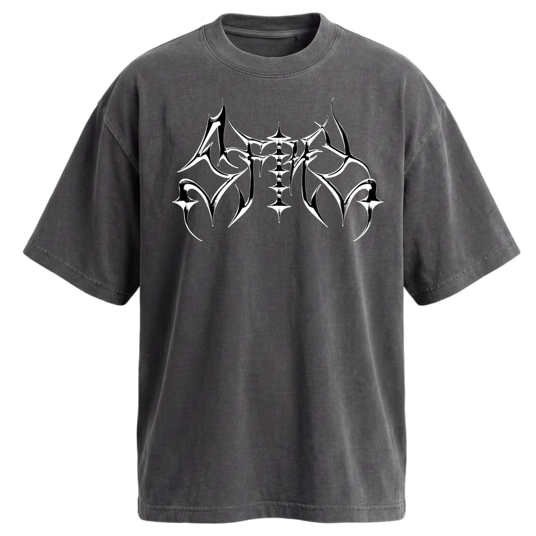 A black oversized T-shirt crafted from premium USA cotton, featuring a bold, abstract white and silver graphic design across the chest that resembles sharp, symmetrical tribal shapes—a perfect choice for those seeking a vintage look with heavyweight t-shirt comfort.