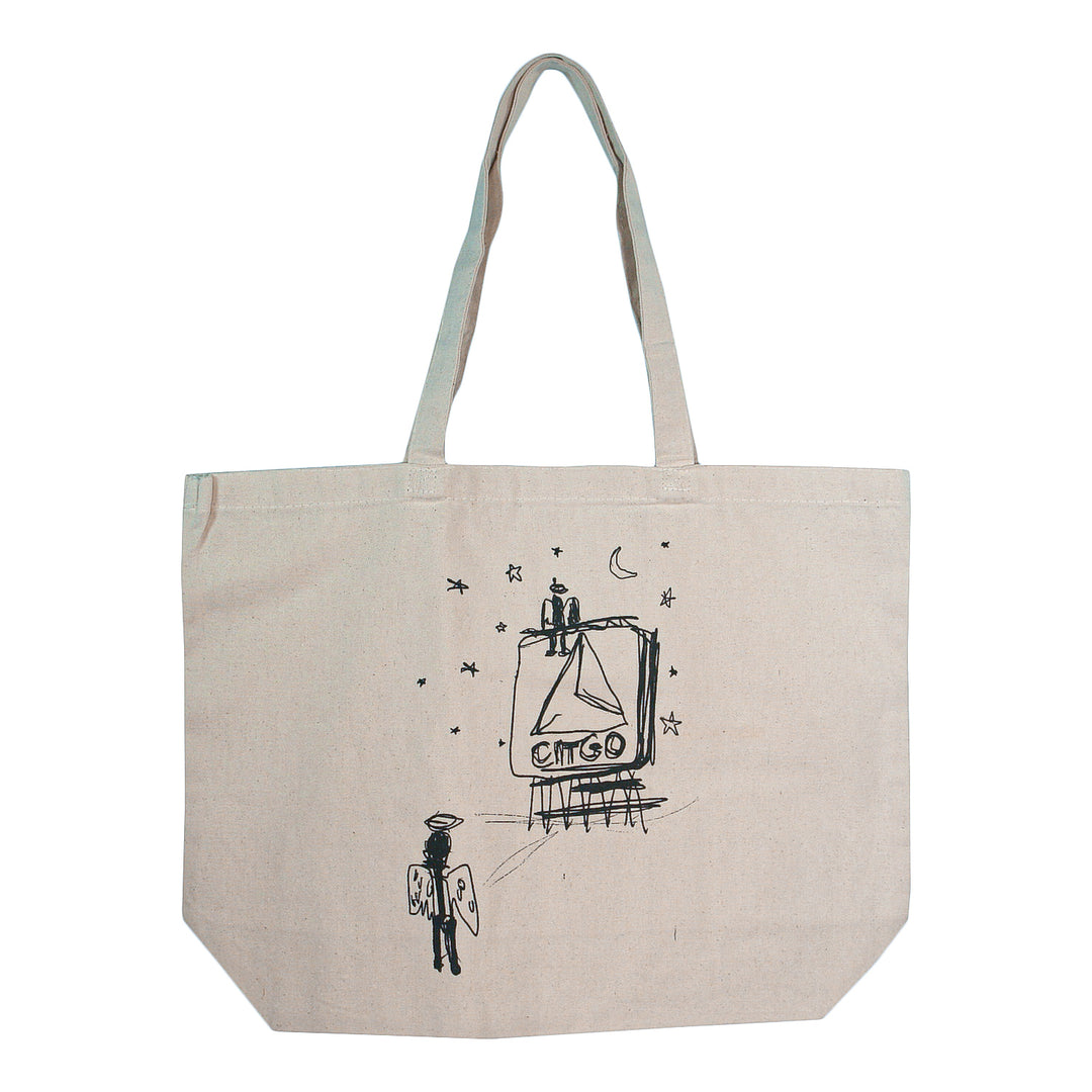 Matt Nathanson’s eco-friendly beige canvas tote features black line art of an angelic figure with wings, abstract symbols, stars, and a crescent moon in front of a billboard structure—a perfect natural bag for everyday use.