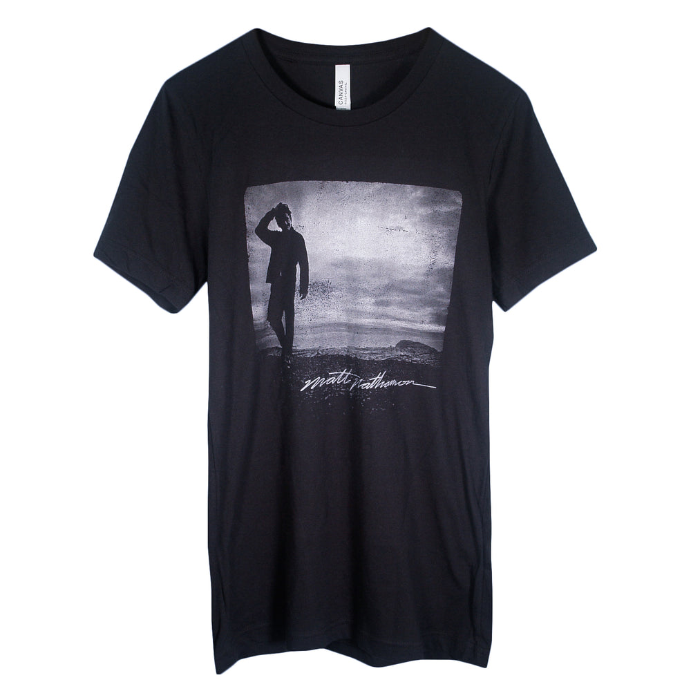Matt Nathanson Black T-Shirt with a grayscale image of a person saluting under a cloudy sky and stylized Solo 2024 text below the image on the front.