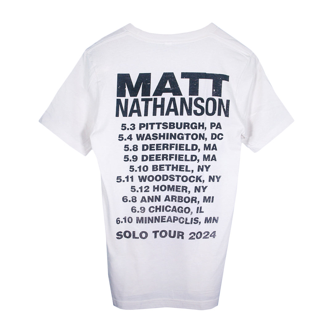 A white Matt Nathanson T-shirt featuring MATT NATHANSON and SOLO TOUR 2024 on the back, plus a tour date list with cities including Pittsburgh, Washington, Deerfield, Bethel, Woodstock, Homer, Ann Arbor, Chicago, and Minneapolis.