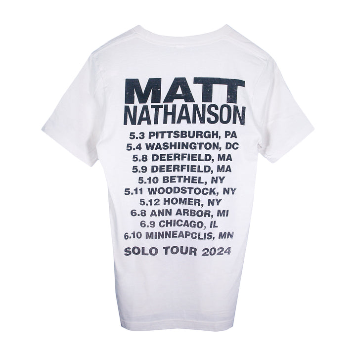 A white Matt Nathanson T-shirt featuring MATT NATHANSON and SOLO TOUR 2024 on the back, plus a tour date list with cities including Pittsburgh, Washington, Deerfield, Bethel, Woodstock, Homer, Ann Arbor, Chicago, and Minneapolis.