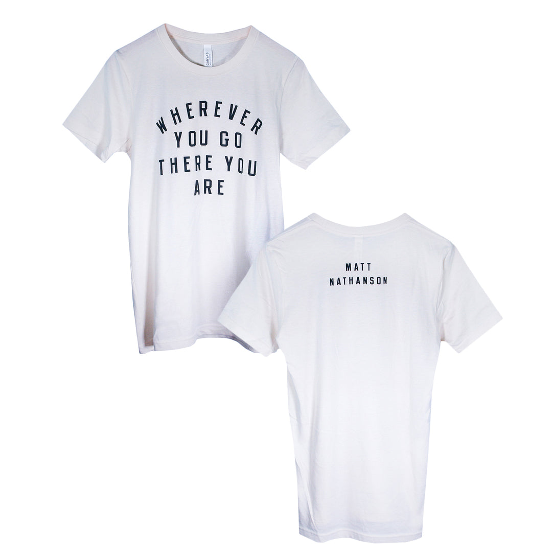 Two white Matt Nathanson T-Shirts are displayed. The front reads WHEREVER YOU GO THERE YOU ARE in black, while “MATT NATHANSON” appears in small black print near the neckline on the back—ideal tees for fans.