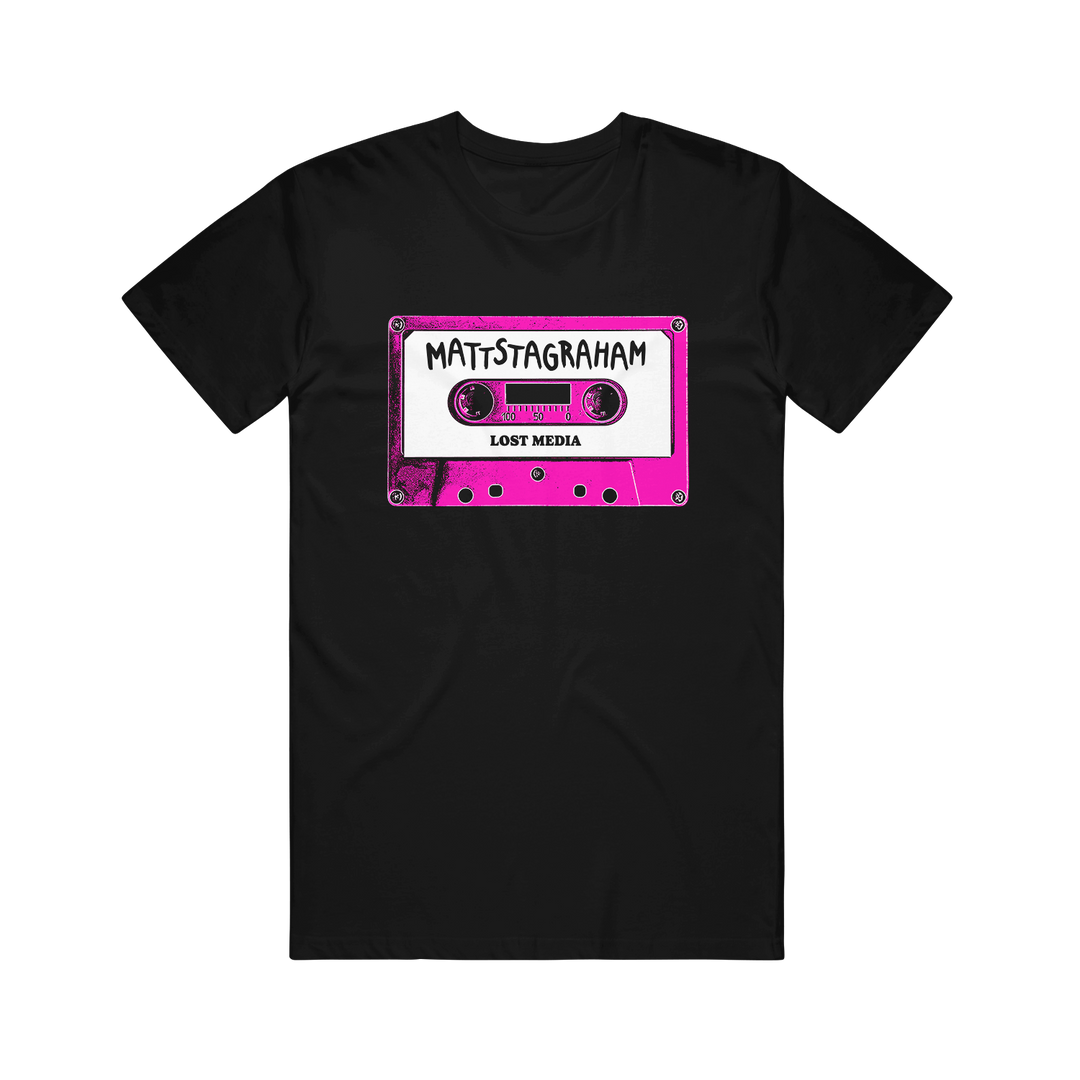 Relax in vintage style with this black Mattstagraham T-shirt, featuring a pink cassette tape graphic labeled "MATTSTAGRAHAM" and "LOST MEDIA" in bold white and black text. Crafted from 100% U.S. cotton, this classic American Apparel tee offers a laid-back fit with retro flair.