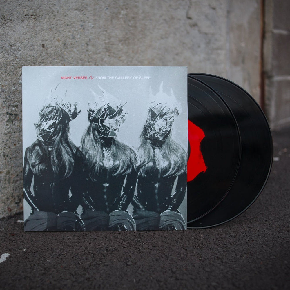 A Night Verses Black/Red Eclipse Double LP of From the Gallery of Sleep sits on asphalt. The cover depicts three long-haired figures with abstract, metallic masks, with two colored records partly showing behind it.