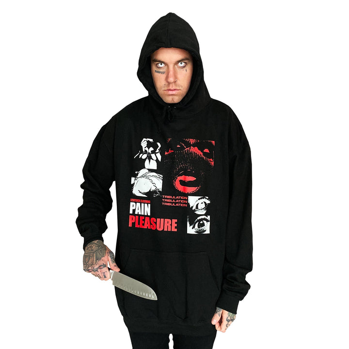 A person wearing a Stay Sick Clothing black hoodie with bold Pain Pleasure graphic grips a large kitchen knife in their right hand, staring intensely ahead against a plain white background.