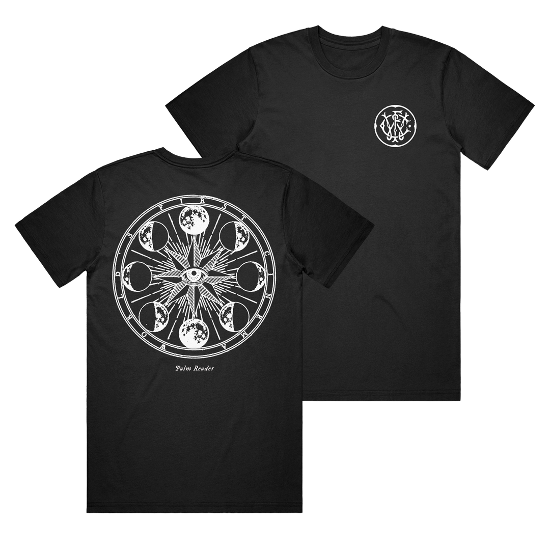 World's First Cinema black Comfort Colors tee featuring a small white ornate symbol on the left chest and a large mystical back print with an eye, sun rays, moon phases, and "Palm Reader" text.
