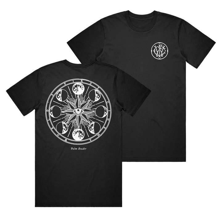 World's First Cinema black Comfort Colors tee featuring a small white ornate symbol on the left chest and a large mystical back print with an eye, sun rays, moon phases, and "Palm Reader" text.