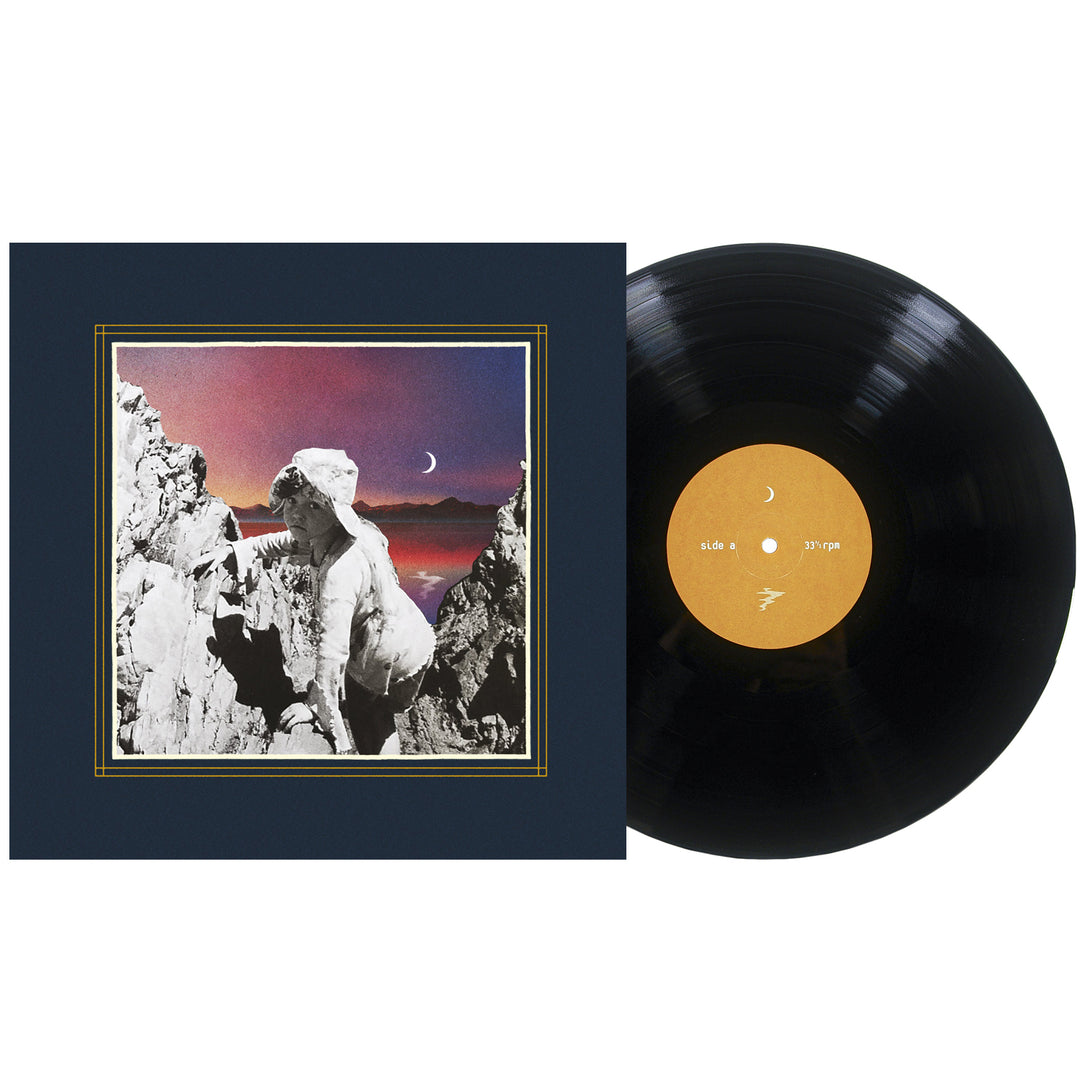 A vinyl record next to its cover, which features a classical statue among rocky mountains with a crescent moon in a colorful dusk sky, as distant galaxies shimmer above the serene landscape.