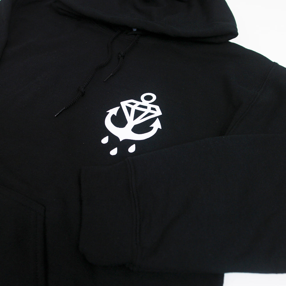 A Phase Black hoodie from Stay Sick Clothing with a white anchor, diamond, and three water droplets graphic on the left chest.