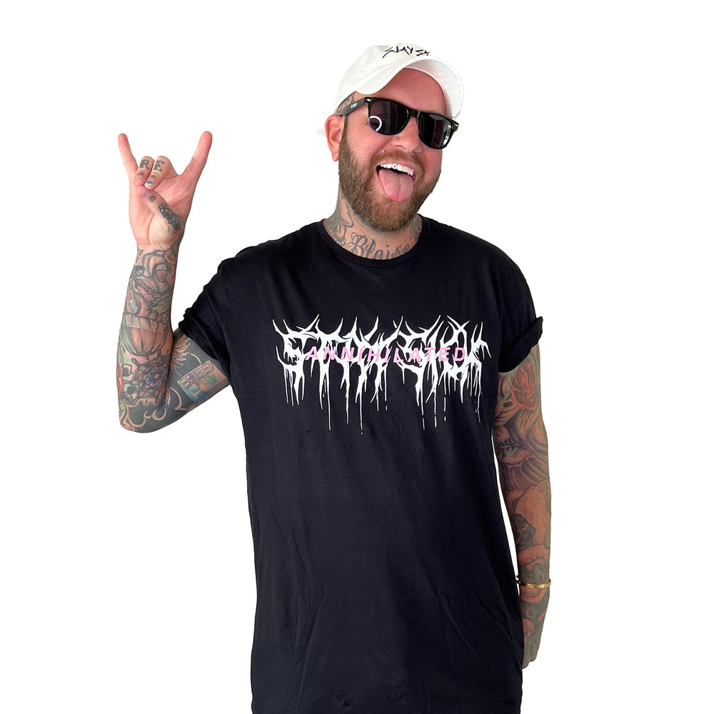 A smiling, tattooed man in sunglasses, a white cap, and a tall black Stay Sick Clothing T-shirt with a white graphic makes the rock on sign against a plain white background.