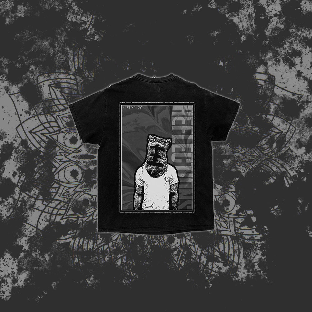 A black Reflections T-shirt features an illustration of a person in a tank top with a paper bag on their head, framed by a rectangle with "RECLUZE" vertically on the right, set against a dark, abstract background.