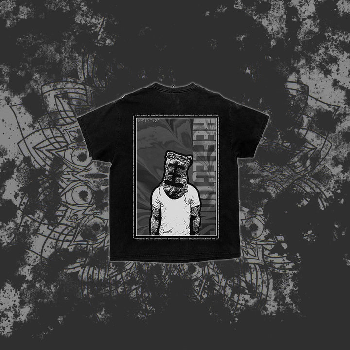 A black Reflections T-shirt features an illustration of a person in a tank top with a paper bag on their head, framed by a rectangle with "RECLUZE" vertically on the right, set against a dark, abstract background.