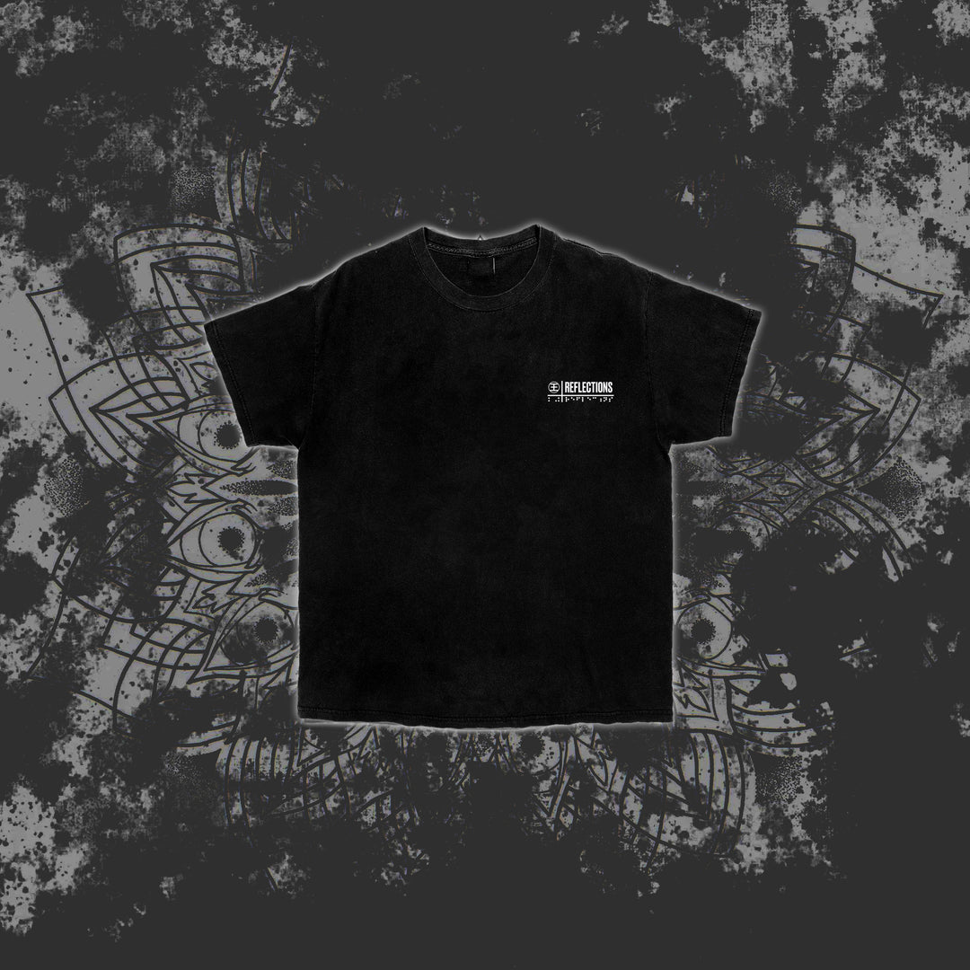 A black Reflections Hammer t-shirt featuring small white text on the left chest, shown on a dark, grunge-patterned background with subtle mandala-like designs—ideal for fans of premium printed t-shirts.