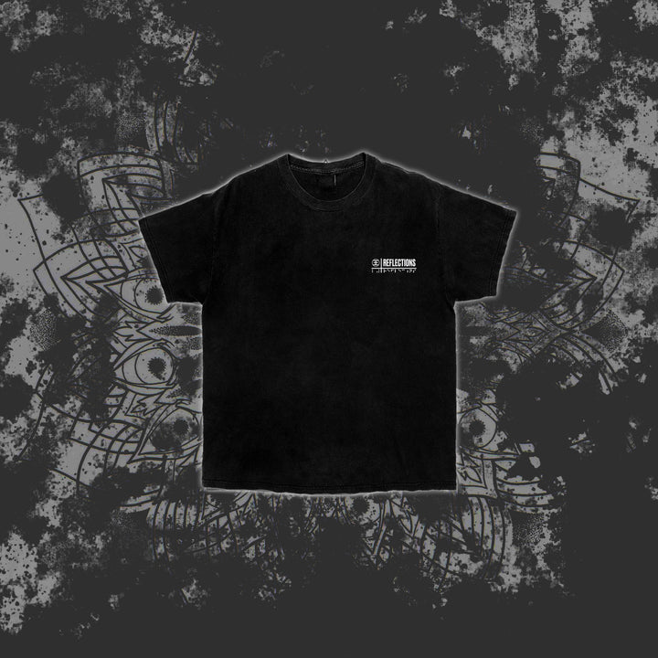 A black Reflections Hammer t-shirt featuring small white text on the left chest, shown on a dark, grunge-patterned background with subtle mandala-like designs—ideal for fans of premium printed t-shirts.