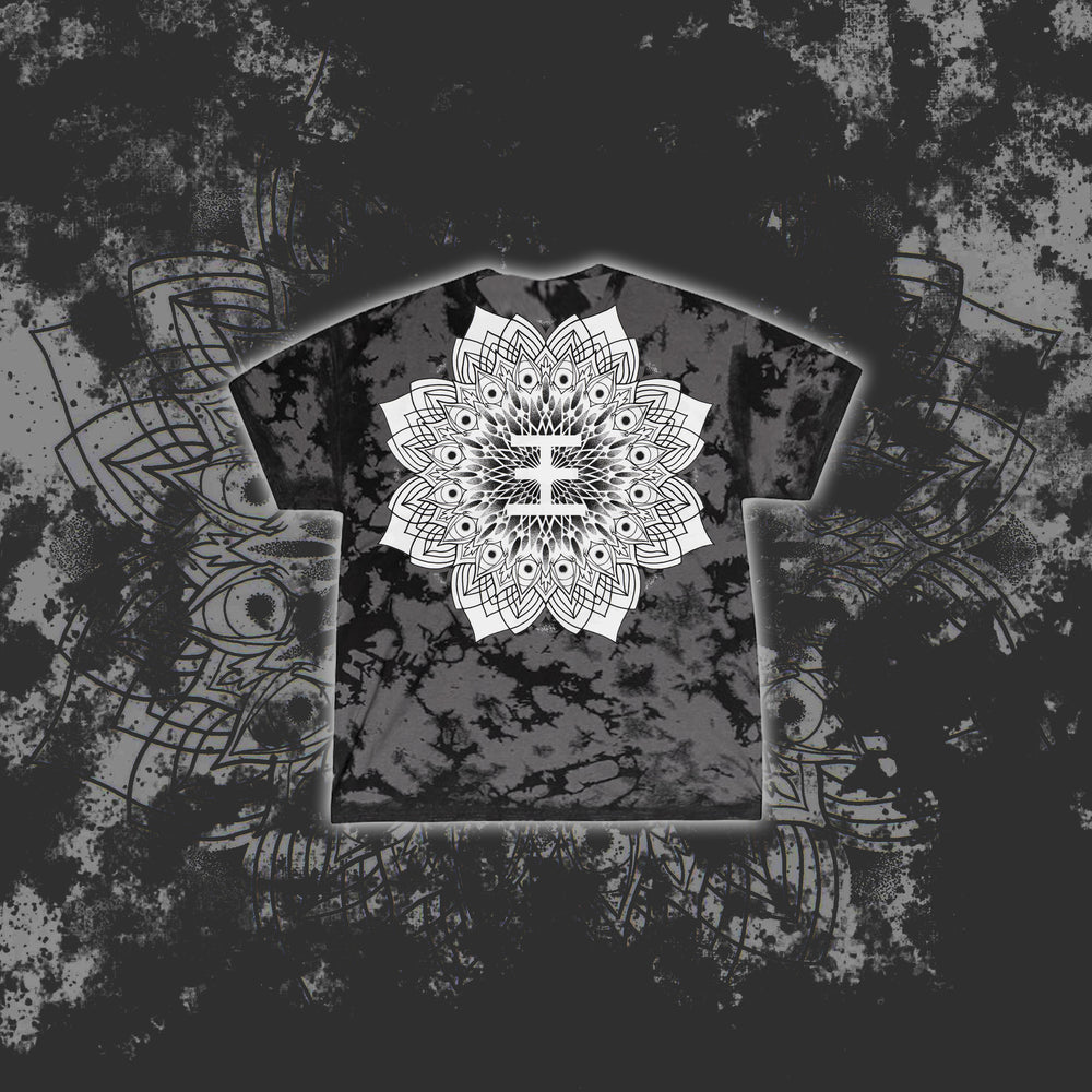 A black and gray tie-dye Reflections T-shirt features a bold white mandala design centered on the chest, set against a matching mandala and splatter background—ideal for fans of printed tees.