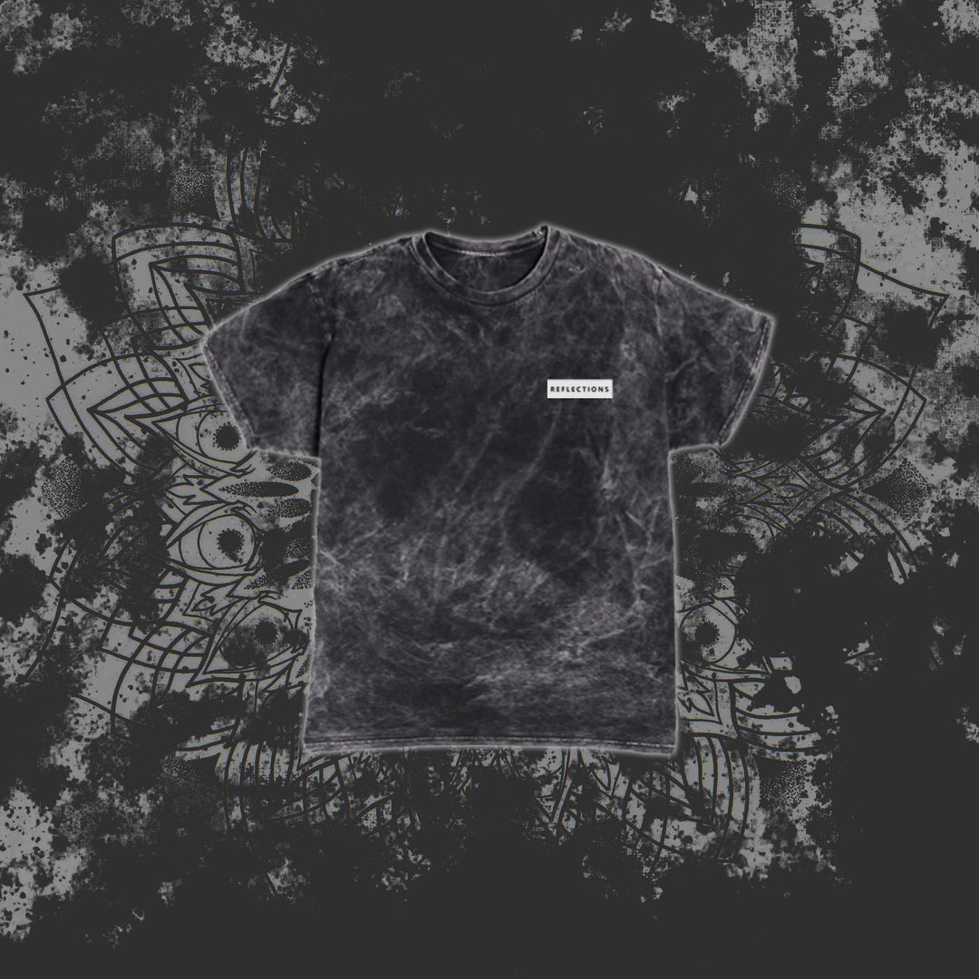 A black marble-pattern T-shirt from Reflections with a small white rectangular label reading RESURRECTION on the left chest, displayed against a grey abstract geometric background.