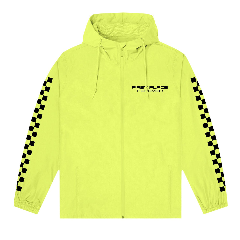 A Stay Sick Clothing Safety Yellow Wind Breaker features black checkered stripes on the sleeves and FIRST PLACE FOREVER printed on the left chest.