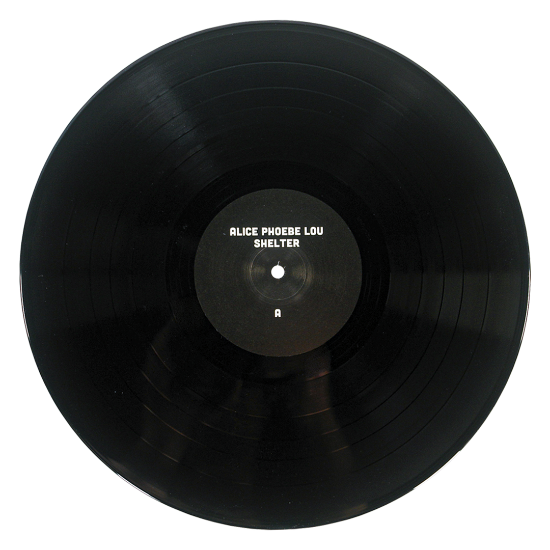 A black vinyl record of Alice Phoebe Lou’s fifth studio album, Shelter, featuring a center label marked with the letter A, is shown against a white background.