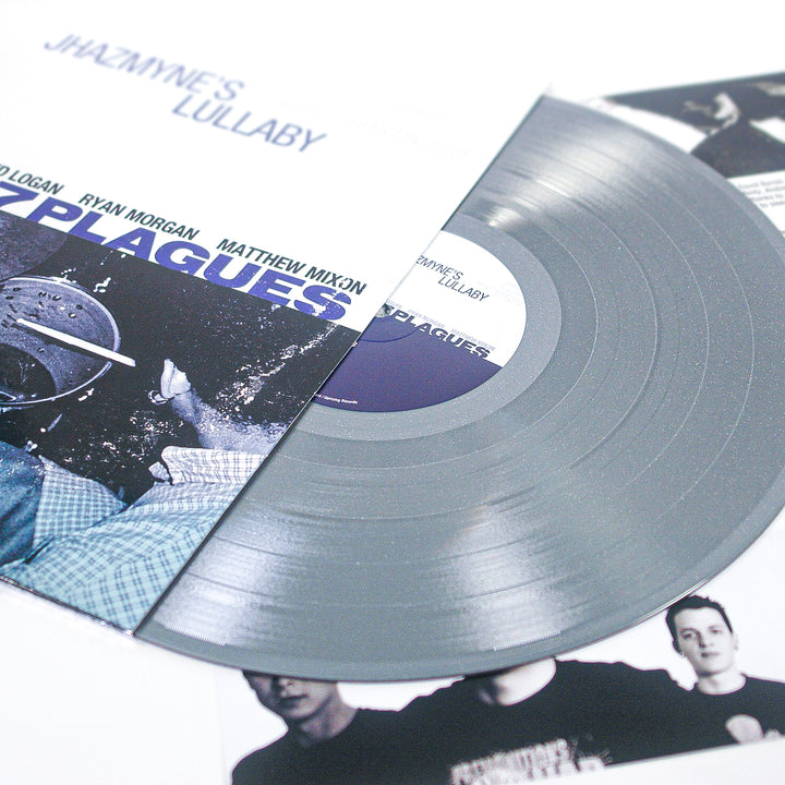 A silver glitter vinyl record partially slides out of its cover, which displays the text PLAGUES and images of band members. Other album artwork and band photos are visible in the background, highlighting this special limited edition vinyl release.
