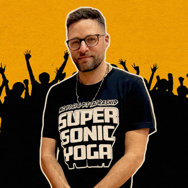 Man wearing a 'Super Sonic Yoga' t-shirt with a yellow and black silhouette background