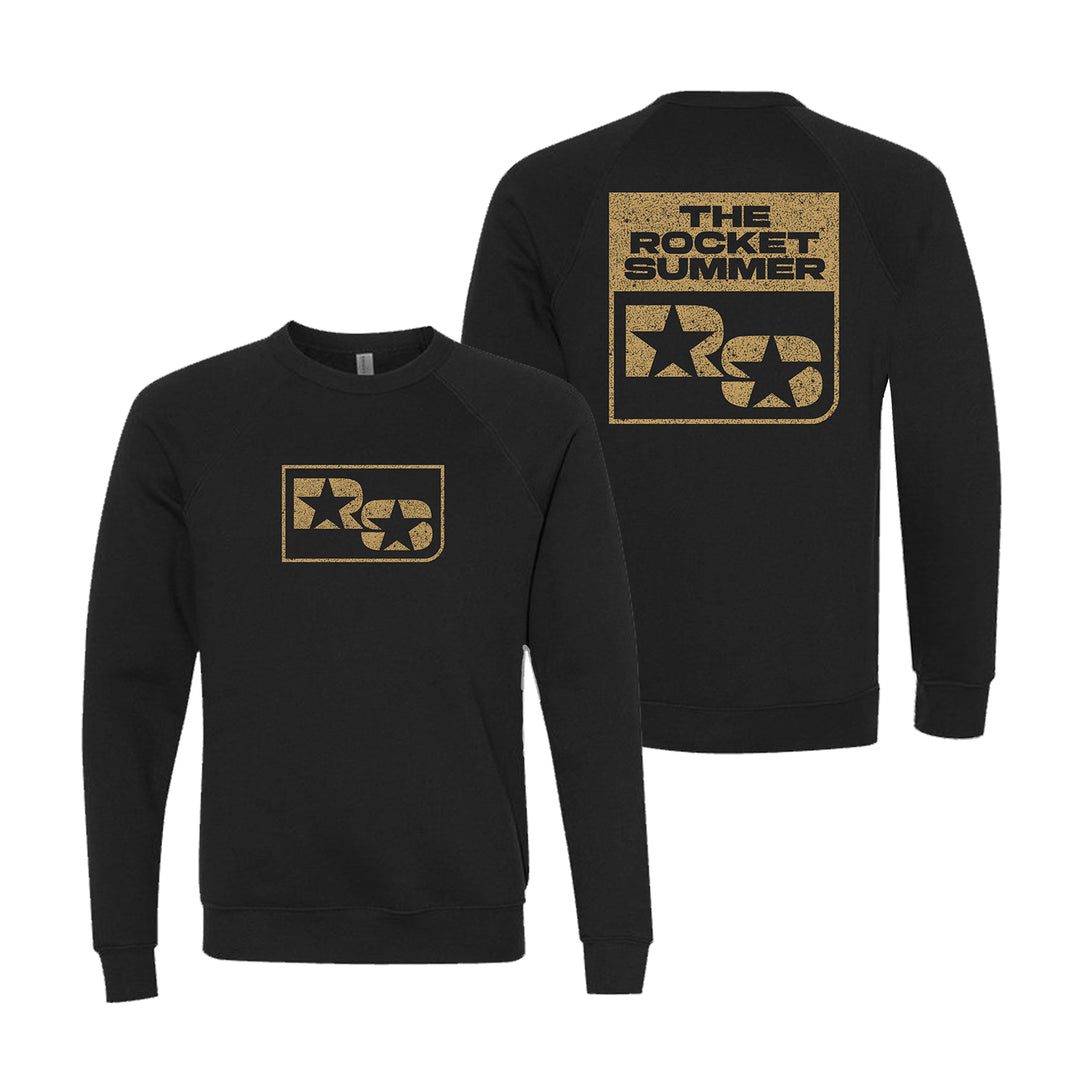 The Rocket Summer unisex black Raglan Crewneck Sweatshirt features a gold TRS star graphic on the front and “THE ROCKET SUMMER” above the TRS logo and star on the back, both in bold, modern font.