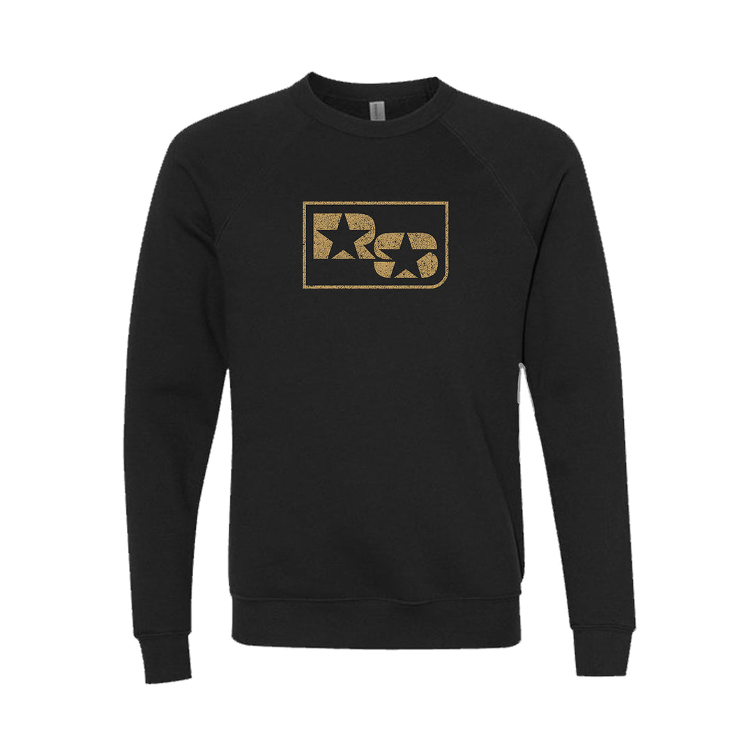 A black unisex Bella and Canvas sweatshirt by The Rocket Summer, featuring a gold rectangular graphic with a star, circular design, and stylized R and C letters on the chest.