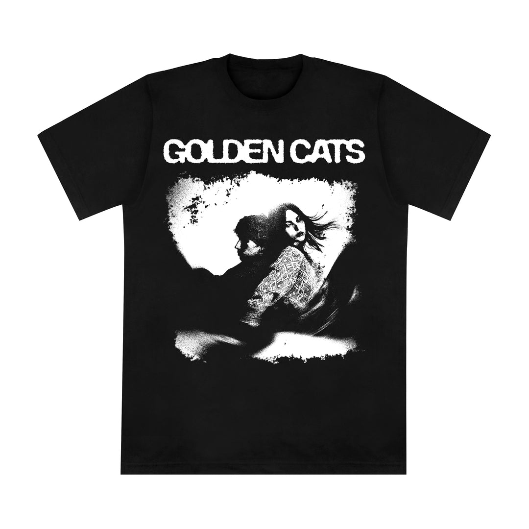 Black American Apparel t-shirt featuring the text GOLDEN CATS above a black and white graphic of two individuals with long hair sitting back-to-back.