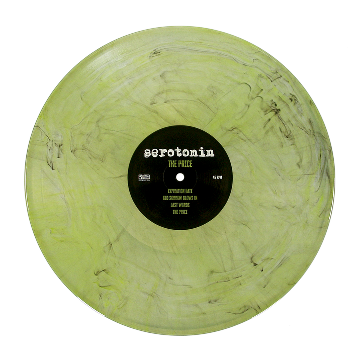 A translucent light green emo punk vinyl record with black marbling and a center label reading serotonin THE PRICE followed by a tracklist.