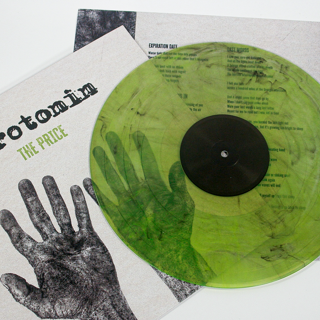 A semi-transparent, marbled green vinyl record from the Nashville emo punk band Serotonin sits atop its album cover, which features a black-and-white graphic of a hand and the title Rotomim: The Price.