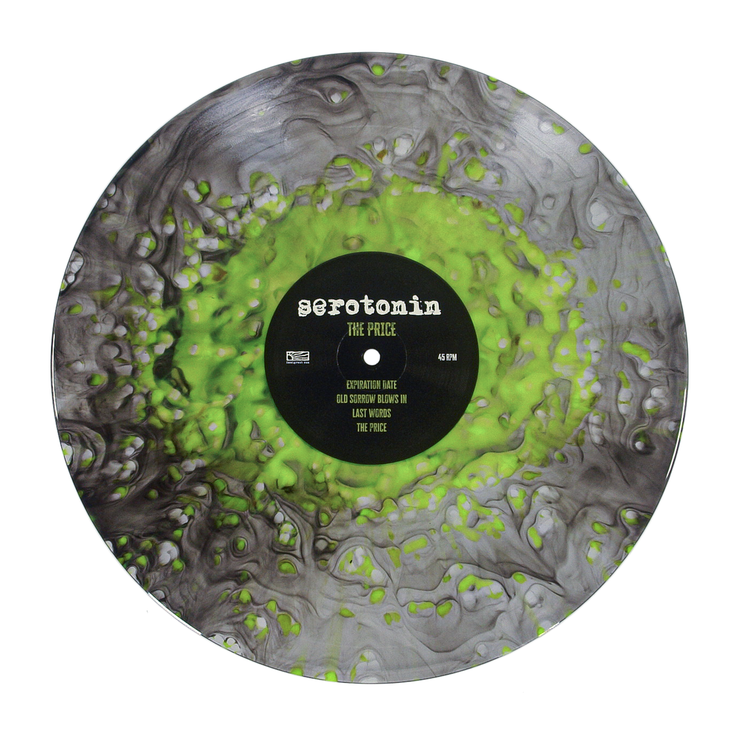 Vinyl record with a black and neon green marbled pattern and a center label for the emo punk band Serotonin, featuring the album title The Price and four track names.