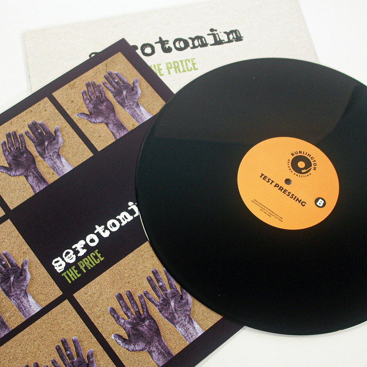 Vinyl record with a Burlington Record Pressing test pressing label, resting on the Serotonin band album cover titled serotonin THE PRICE.