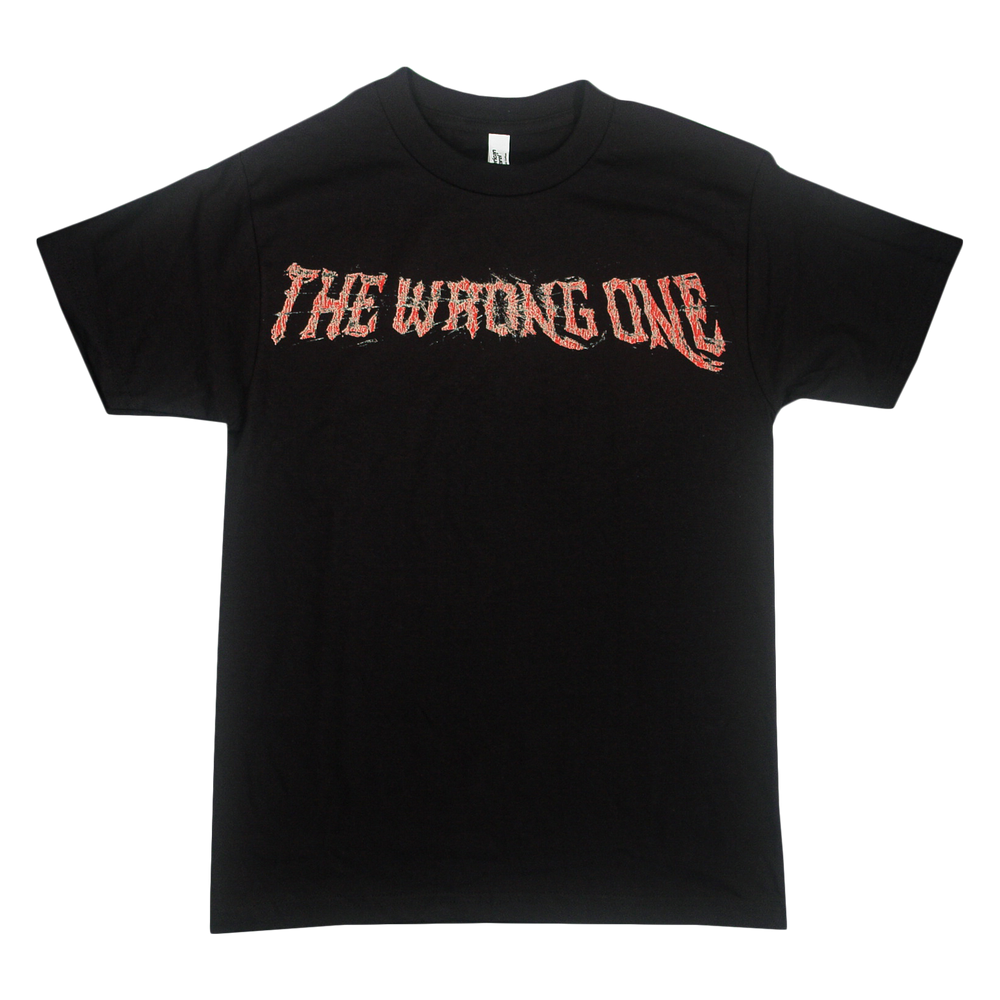 Black T-shirt from Sorry X featuring bold, jagged red text across the chest that reads “THE WRONG ONE.” Made from 100% U.S. cotton, this relaxed fit American Apparel tee includes short sleeves and a classic round neckline.