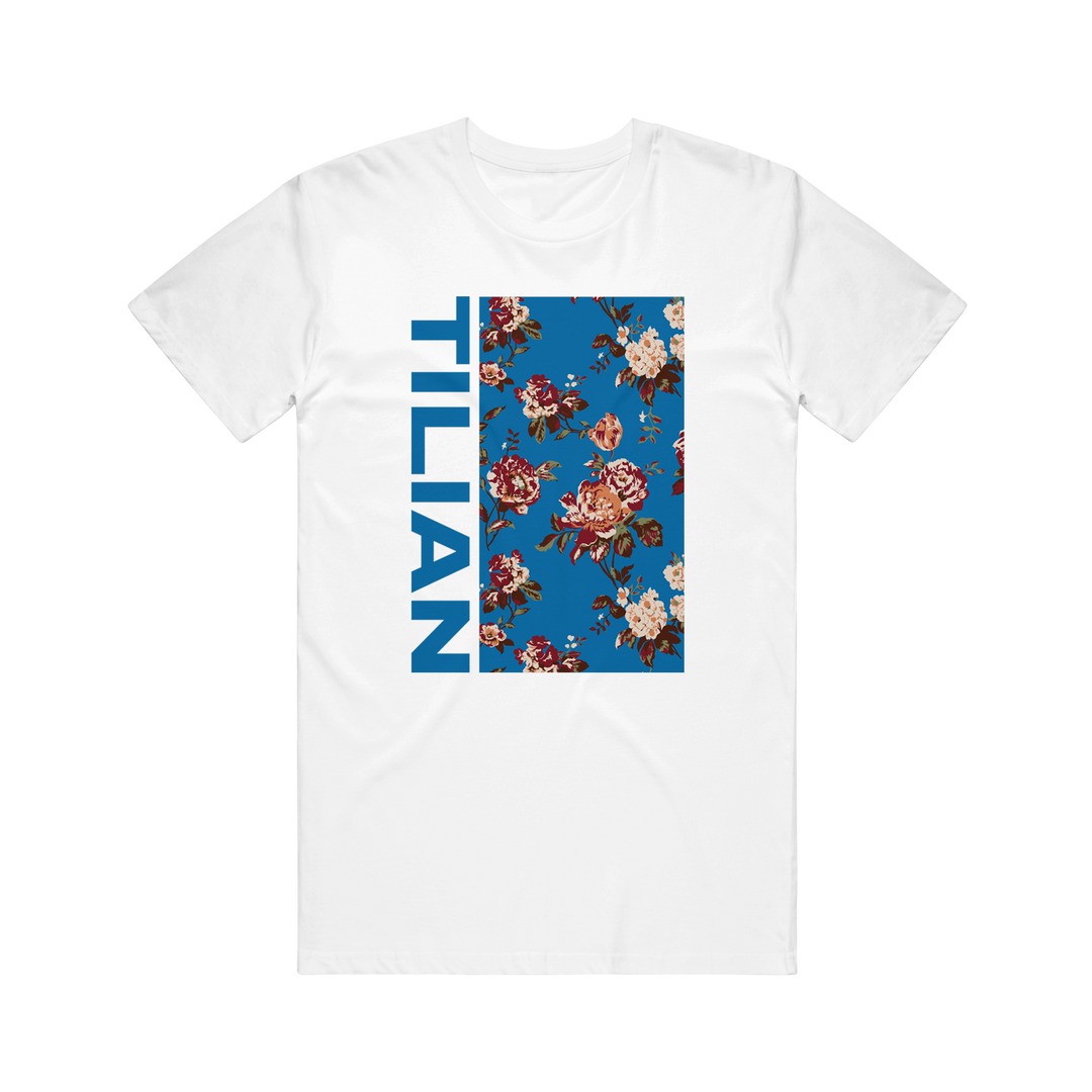 Tilian white T-shirt with a vertical blue rectangle, floral pattern, and bold blue TILIAN lettering down the left side of the rectangle.